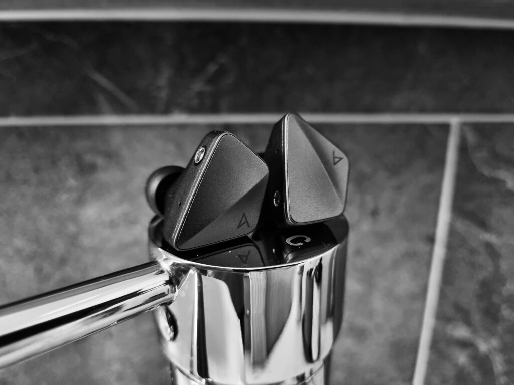 AK Zero1 IEM sitting on a sink handle in Black and White